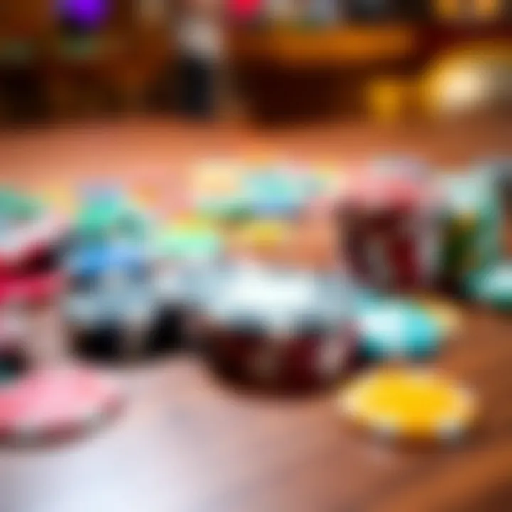 Casino chips on a table A collection of colorful casino chips spread out on a wooden table with a few chips stacked together.