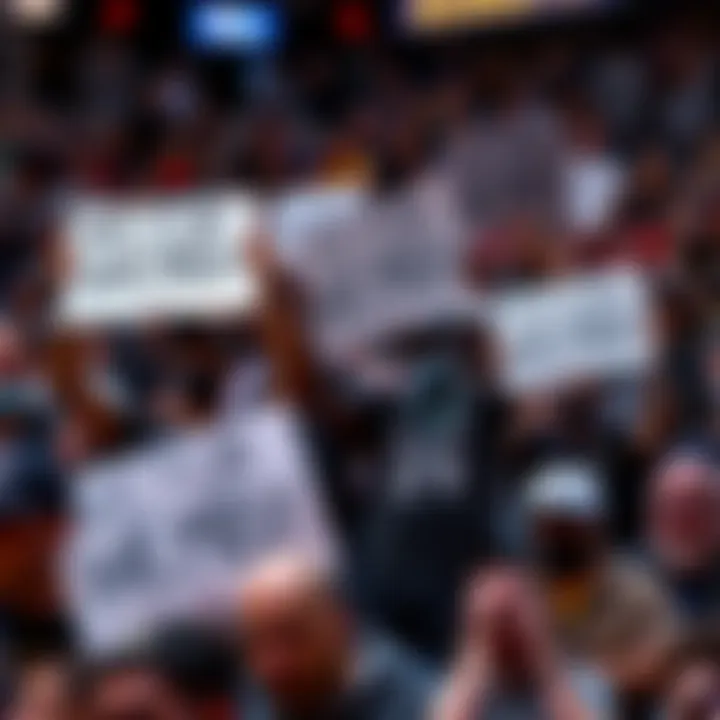 Group of basketball fans holding signs demanding trade of Victor Wembanyama during a Spurs game