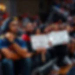 A group of fans showing frustration during a basketball game, some with signs questioning a player's commitment