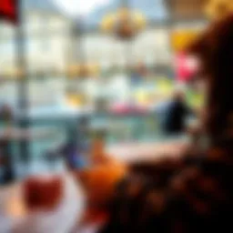 A person playing GGPoker on a smartphone while sitting at a table in a café in Switzerland.