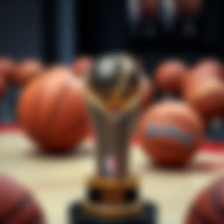 A close-up of the NBA Championship trophy with basketballs in the background