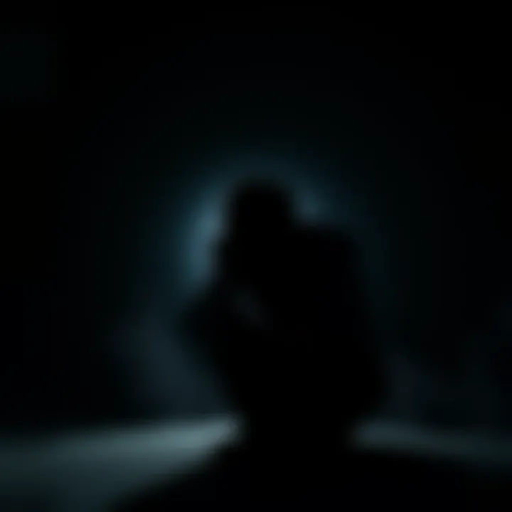 A silhouette of a person sitting alone, head down with hands covering their face, representing emotional pain.